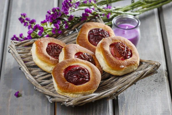 Round buns with plum on wooden table — Stock Photo, Image