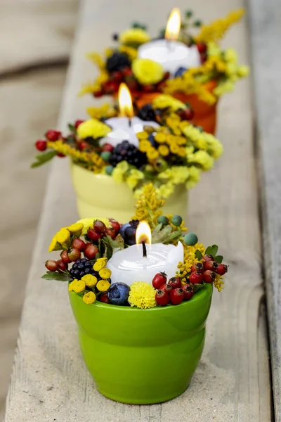 Świecznik ozdobiony jesienne kwiaty i inne rośliny — Zdjęcie stockowe