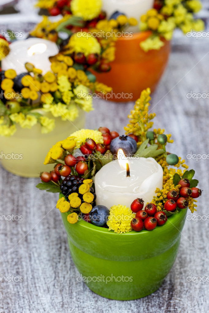 Candle holder decorated with autumn flowers and other plants Stock