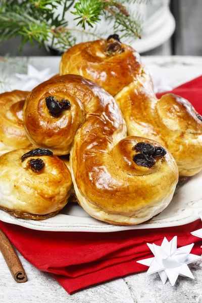 Traditional swedish buns in christmas setting. A saffron bun — Stock Photo, Image
