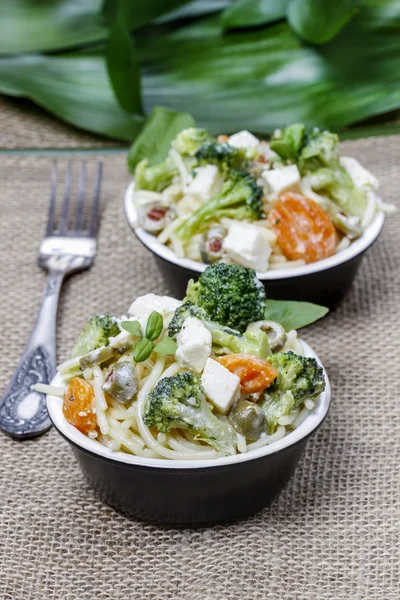 Vegetarian pasta with broccoli, ricotta, basil, carrot and olive — Stock Photo, Image