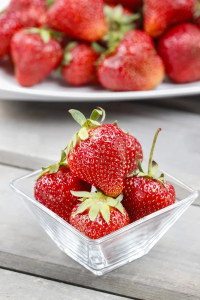 Fresh ripe strawberries in glass bowl — Stock Photo, Image