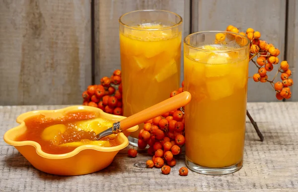 Orange juice and jelly dessert with apricots on wooden table — Stock Photo, Image