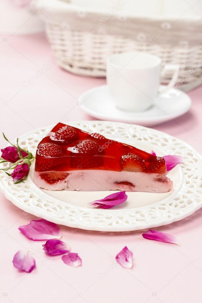 Piece of strawberry cake in pink romantic table setting