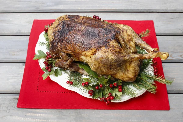 Baked goose on wooden table. Popular christmas dish — Stock Photo, Image