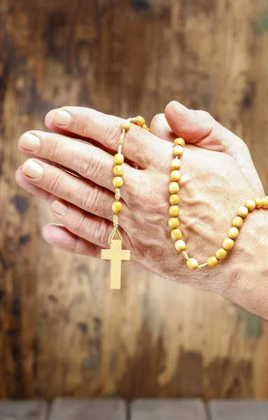 Hands holding wooden rosary — Stock Photo, Image