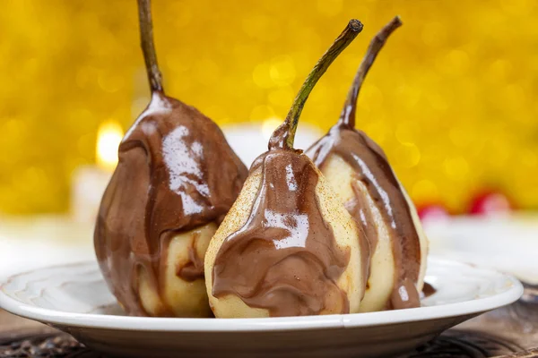 Pear in chocolate, yellow background — Stock Photo, Image