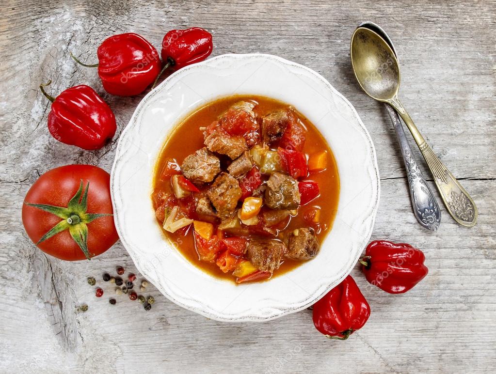 Top view of tomato soup with fresh vegetables and meat