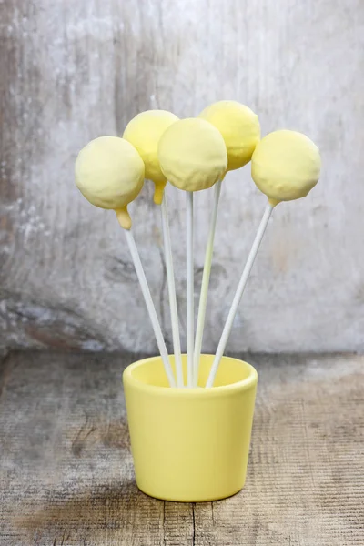 Yellow cake pops på träbord — Stockfoto