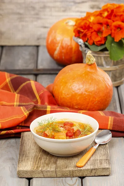 Miska pomidory i papryka zupy na drewnianym stole. ustawienie jesień. — Zdjęcie stockowe
