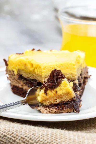 Piece of yellow and brown cake on wooden table. Selective focus — Stock Photo, Image