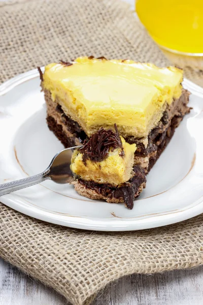 Piece of yellow and brown cake on wooden table. Selective focus — Stock Photo, Image