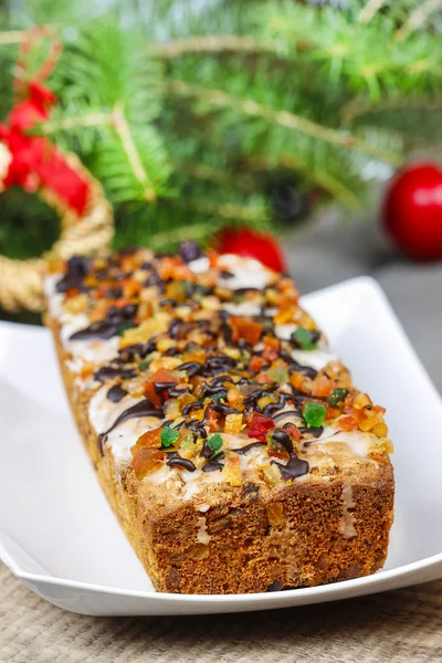 Fruitcake in christmas setting — Stock Photo, Image