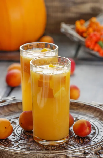 Orange drink on wooden table, selective focus — Stock Photo, Image