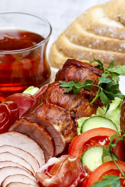 Sliced sausage on wooden table — Stock Photo, Image