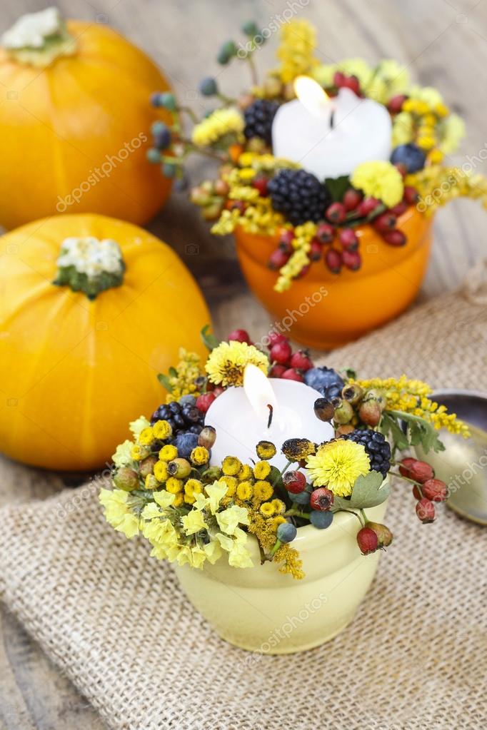 Candle holder decorated with autumn flowers and other plants Stock