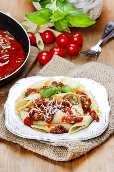 Penne with dried tomatoes. Italian cuisine — Stock Photo, Image