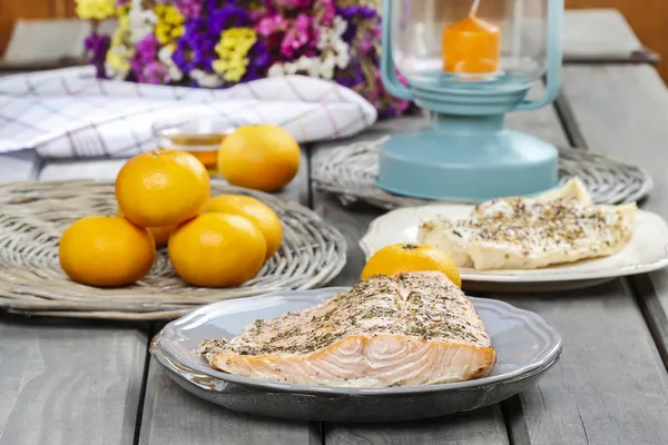 Baked salmon on grey plate. Fresh fruits around. Delicious — Stock Photo, Image