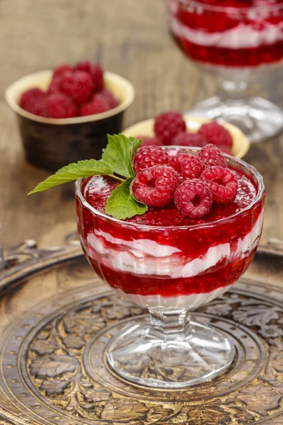 Raspberry dessert on wooden table — Stock Photo, Image