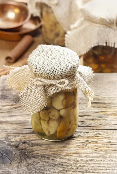 Pickled mushrooms in transparent glass jar — Stock Photo, Image
