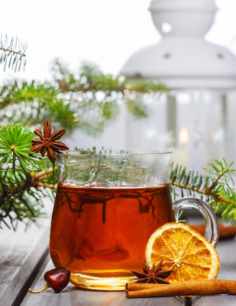 Cup of tea in beautiful christmas setting. Fir branch and white