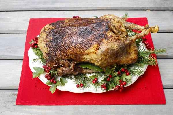 Baked goose on wooden table. Popular christmas dish. Copy space — Stock Photo, Image