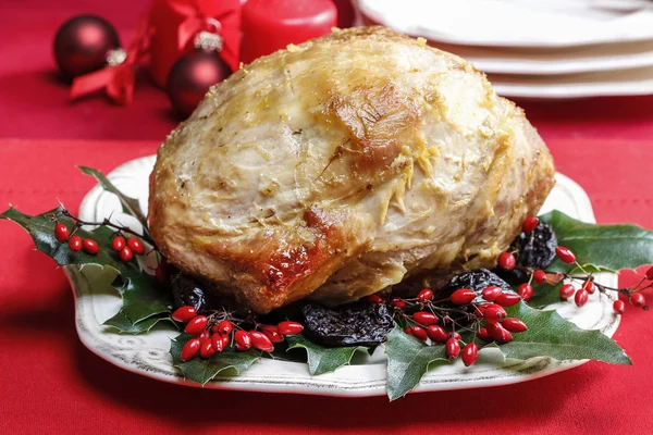 Daging babi panggang dengan prem kering di atas meja natal — Stok Foto