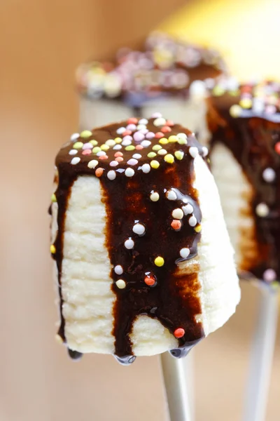 Banana cake pops with chocolate and colorful sprinkles — Stock Photo, Image