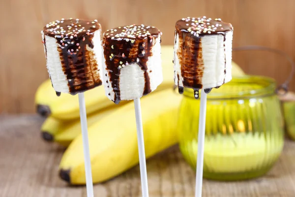 Banana cake pops with chocolate and colorful sprinkles — Stock Photo, Image