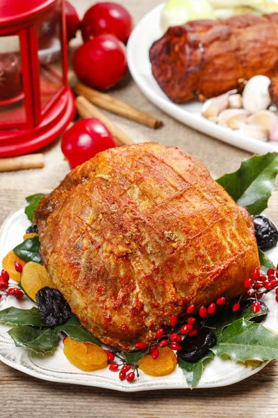 Baked pork with dried apricots on christmas table — Stock Photo, Image