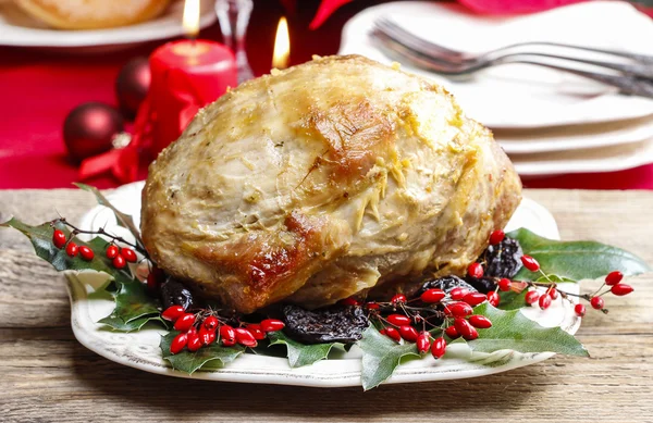 Baked pork with dried plums on christmas table — Stock Photo, Image