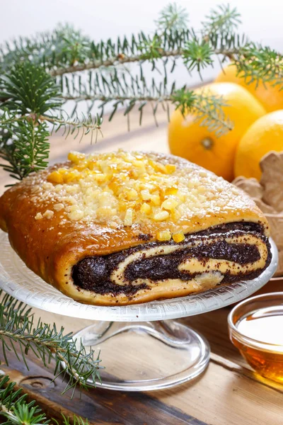 Poppy seed cake on glass cake stand under fir branch. Christmas — Stock Photo, Image