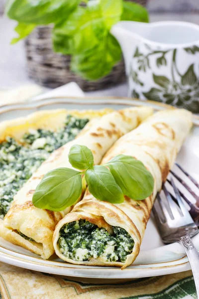 Mediterranean cuisine: crepes stuffed with cheese and spinach — Stock Photo, Image