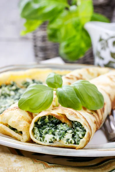 Mediterranean cuisine: crepes stuffed with cheese and spinach — Stock Photo, Image