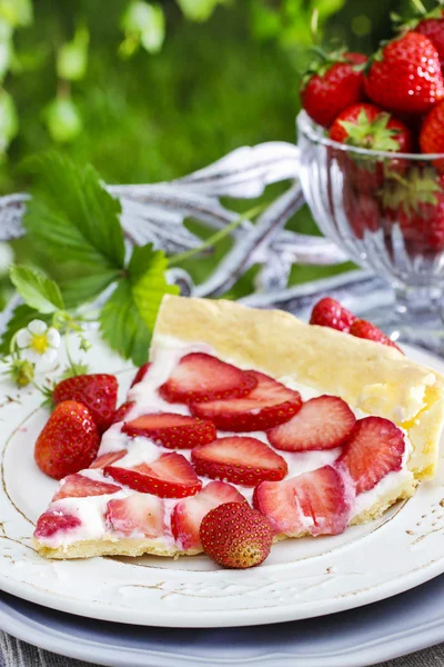 Strawberry cake on wooden tray in summer garden — Stock Photo, Image