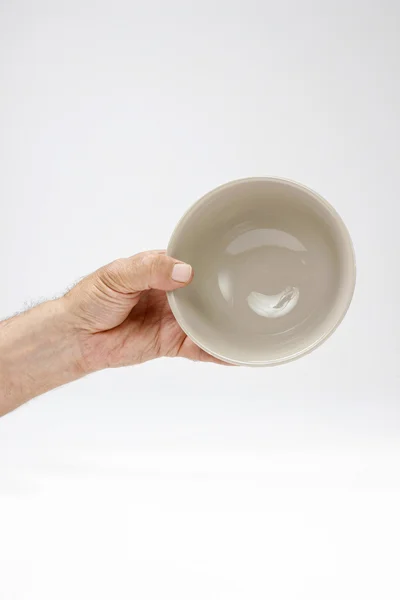 Hungry man holding empty bowl — Stock Photo, Image