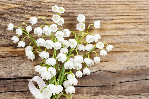 Lily of the valley flowers on wooden background. — Stock Photo, Image