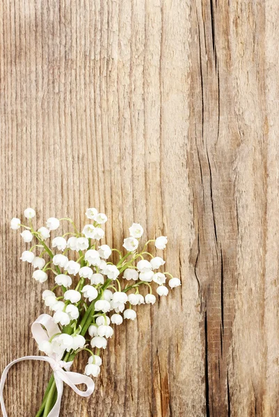 Lys de la vallée fleurs sur fond de bois . — Photo