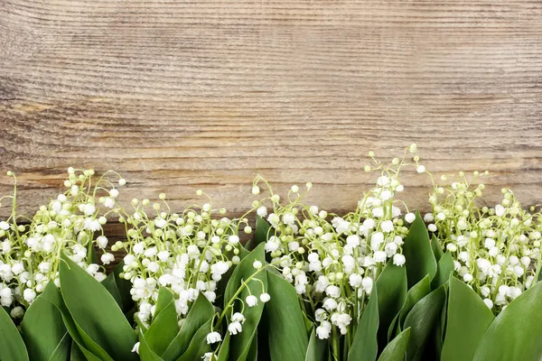 Lily of the valley flowers on wooden background. — Stock Photo, Image