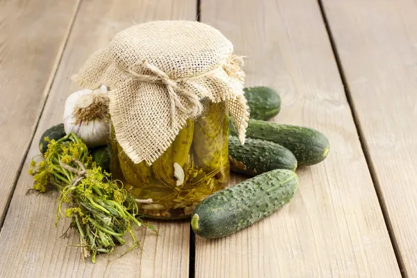 Pickled cucumbers in glass jar — Stock Photo, Image