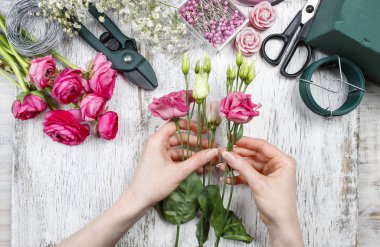 Çiçekçi iş başında. kadın güzel buket pembe eustoma yapma 