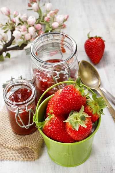 Bucket of strawberries on wooden table — Stock Photo, Image