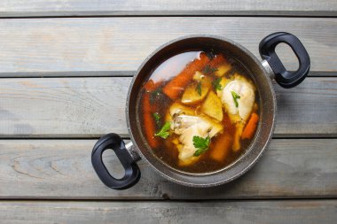 Top view of chicken soup on wooden table. Copy space clipart