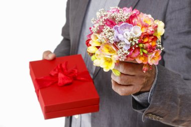 Man holding colorful bouquet of freesia flowers and red box with clipart