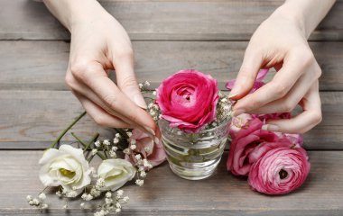 Woman making floral wedding decorations. Tiny bouquet of beautif clipart