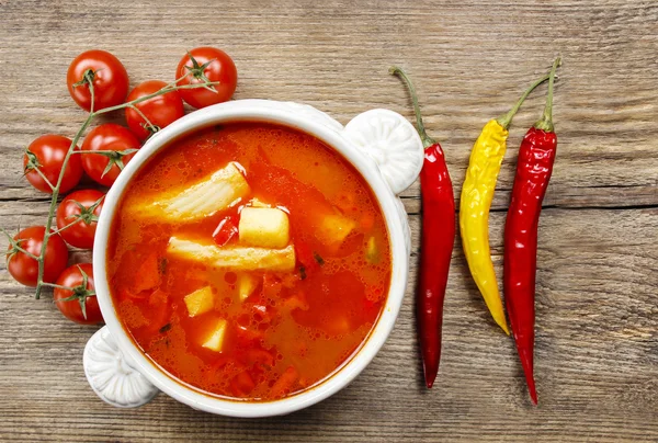 Bowl of tomato soup on wooden table — Stock Photo, Image