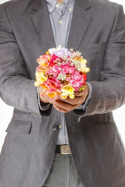 Man holding bouquet of colorful freesia flowers — Stock Photo, Image