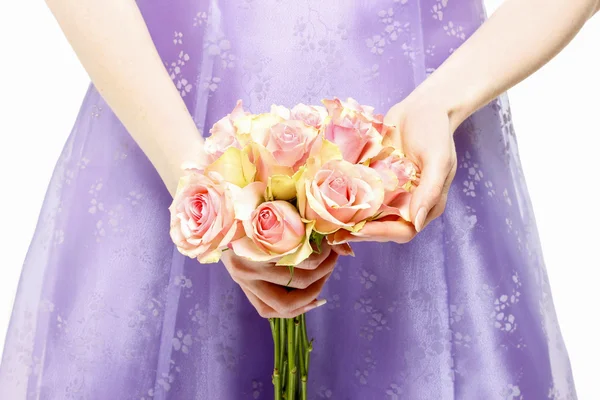 Dama de honra em vestido violeta segurando buquê de rosas rosa — Fotografia de Stock