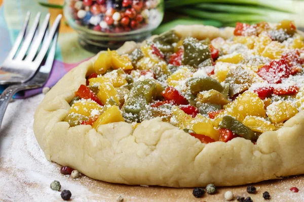 Vegetable galette on wooden kitchen board before baking. — Stock Photo, Image