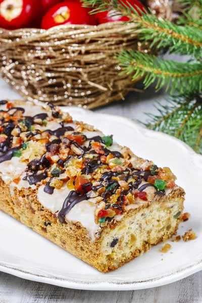 Fruitcake with dried fruits and nuts in christmas setting — Stock Photo, Image